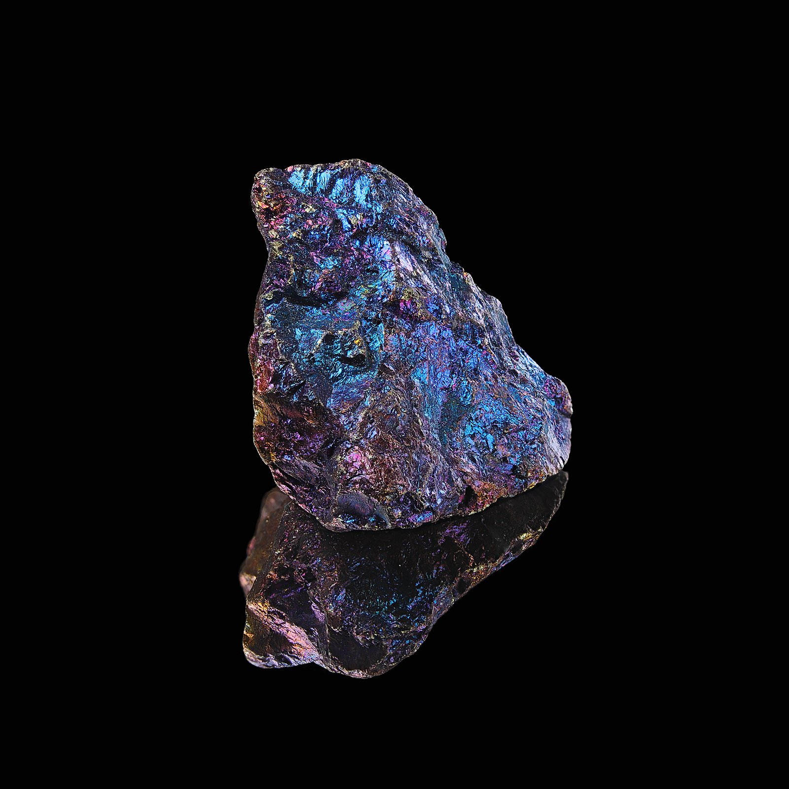 Peacock copper ore, also known as bornite, is a sulfide mineral with the chemical formula Cu5FeS4. It is recognized for its striking iridescent colors, which resemble a peacock's feathers, and is an important source of copper.
