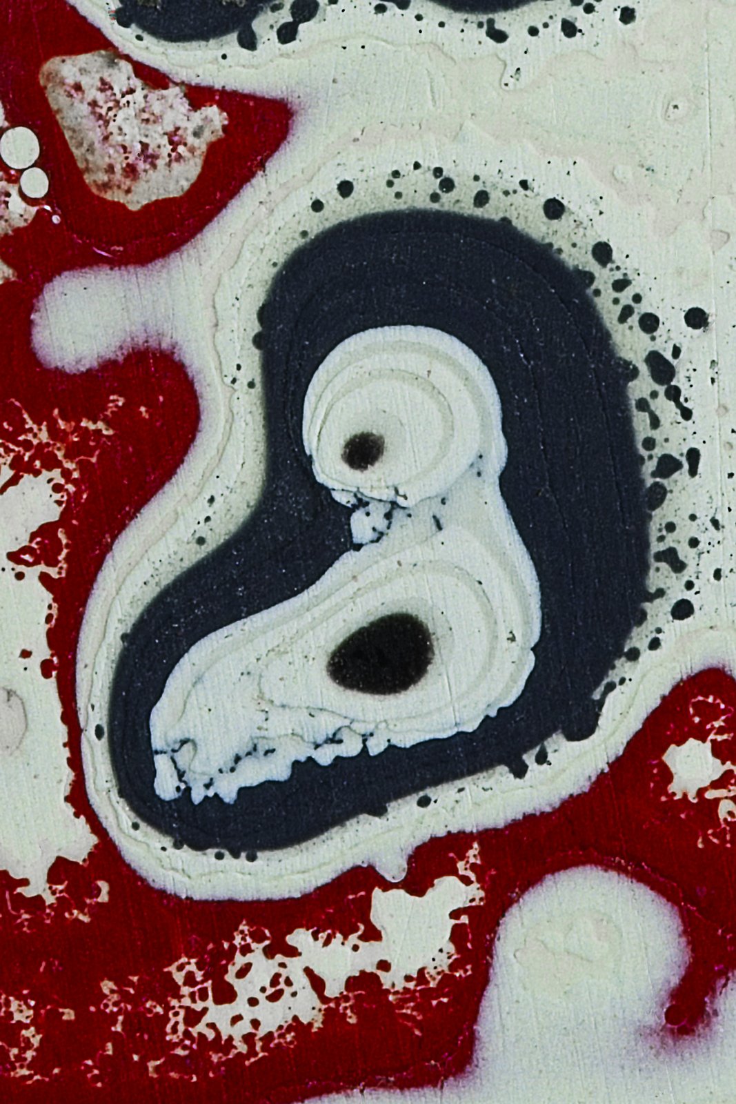 Fordite, also known as Motor Agate, is a unique automotive enamel material with an interesting history. The original layered automotive paint slag “rough” was made incidentally, years ago, by the now extinct practice of hand spray-painting multiples of production cars in big automotive factories. 
The oversprayed paint in the painting bays gradually built up on the tracks and skids that the car frames were painted on. Over time, many colorful layers built up there. These layers were hardened repeatedly in the ovens that the car bodies went into to cure the paint. Some of these deeper layers were even baked 100 times. 
Eventually, the paint build-up would become obstructing, or too thick and heavy, and had to be removed. As the story goes, some crafty workers with an eye for beauty realized that this unique byproduct was worth salvaging. It was super-cured, patterned like psychedelic agate, and could be cut and polished with relative ease! 