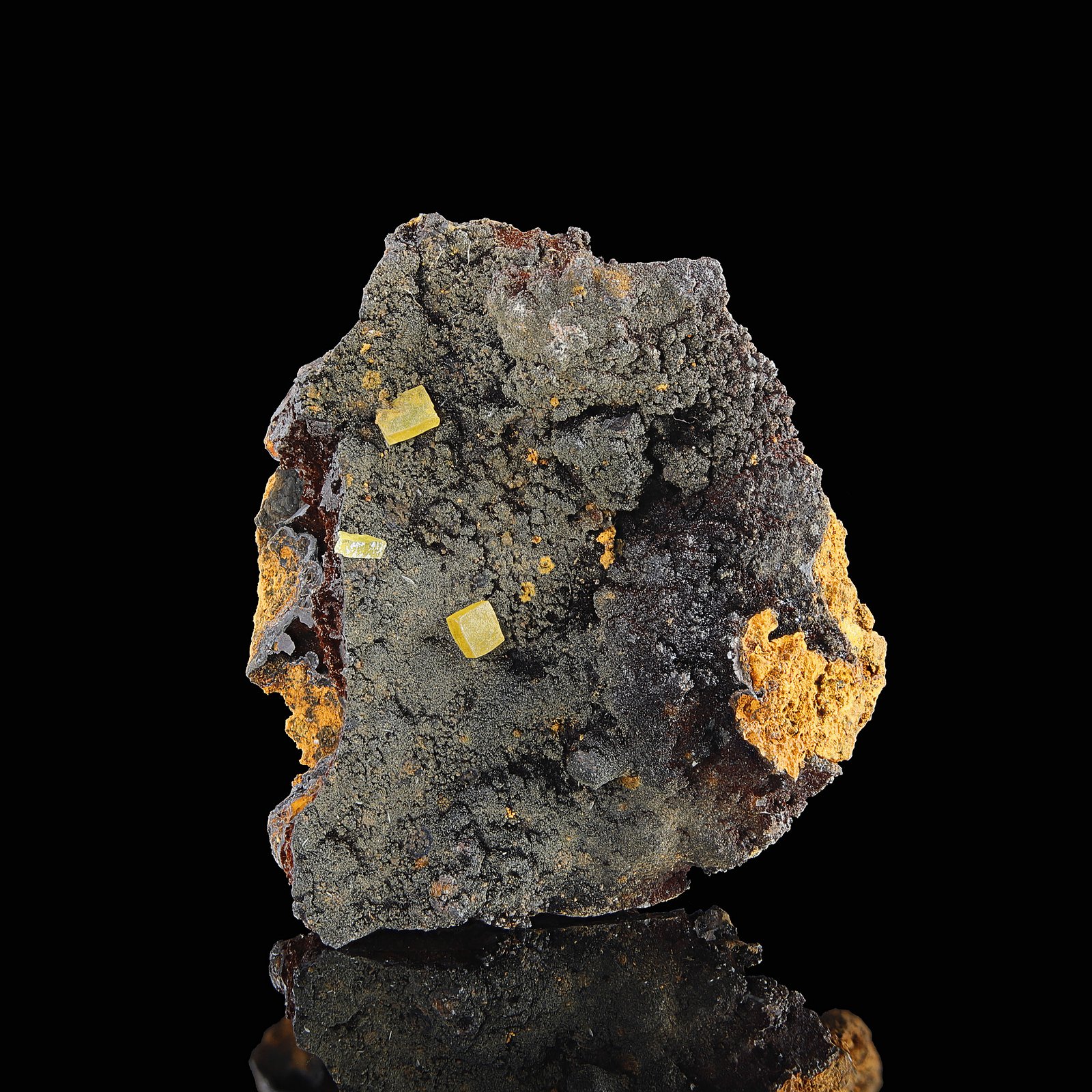 Yellow Wulfenite Crystals and orange Mimetite coating on host rock from the Ojuela Mine in Durango, Mexico.
